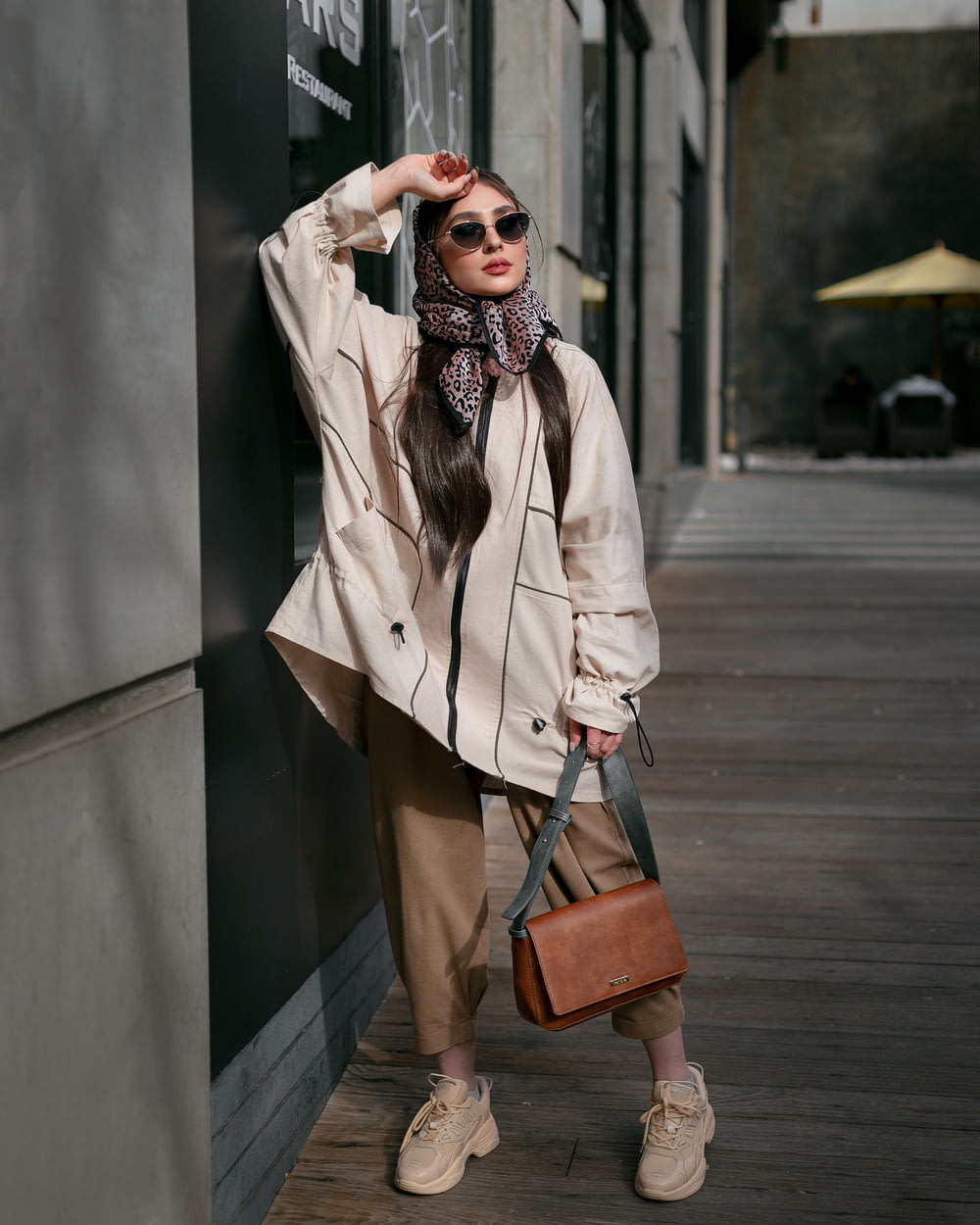 a woman wearing a coat and sunglasses
