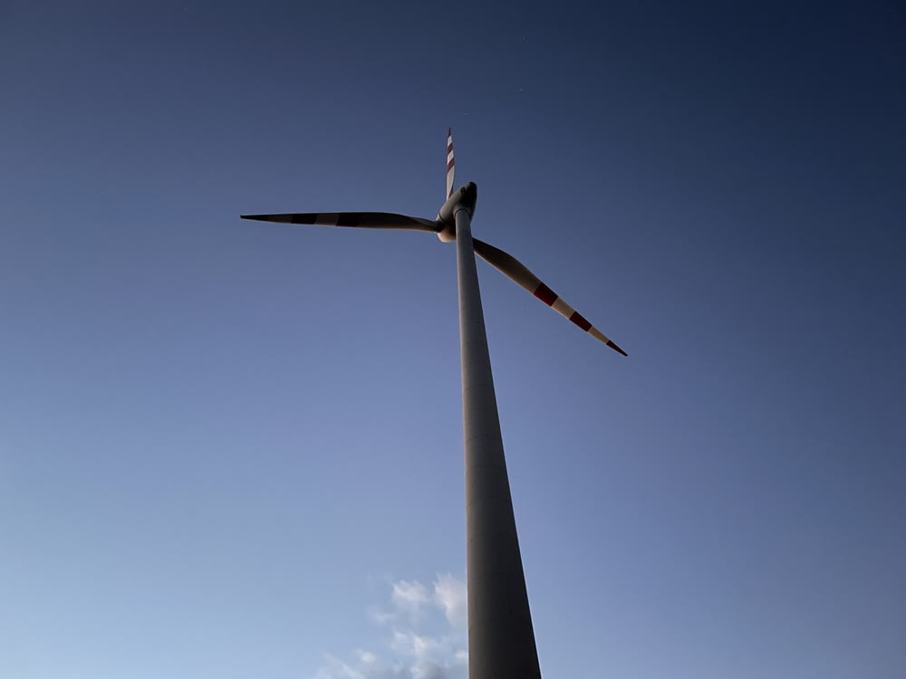 a wind turbine against a blue sky