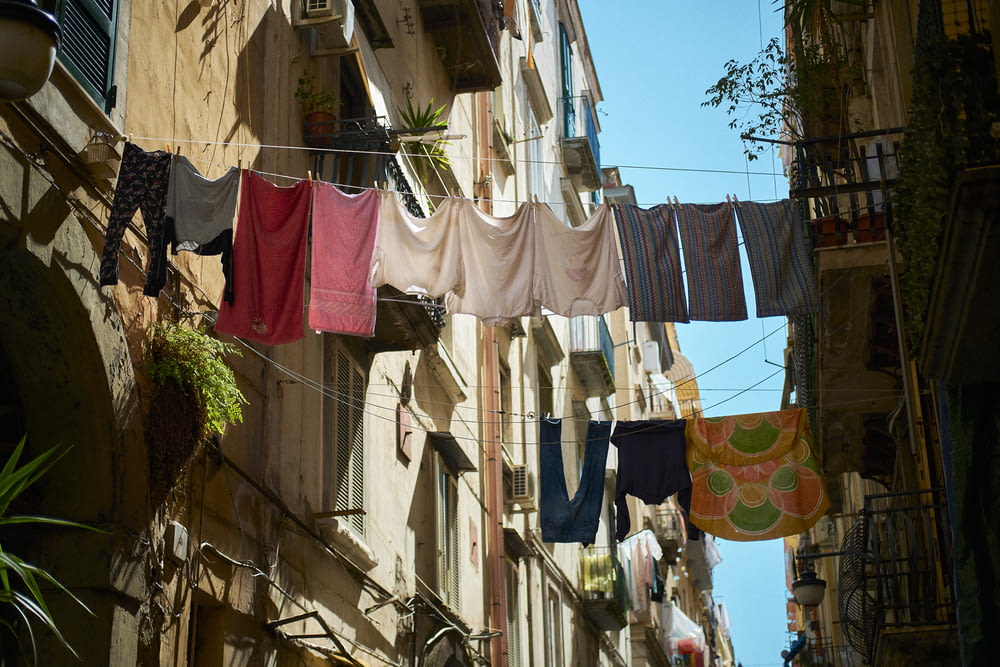 a row of clothes on a line on a street