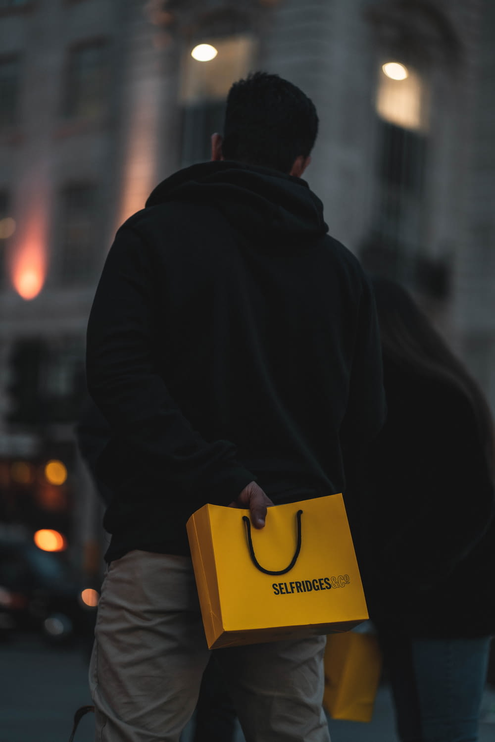a man carrying a yellow box