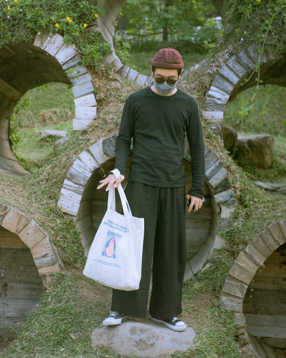 a person wearing a mask and holding a bag