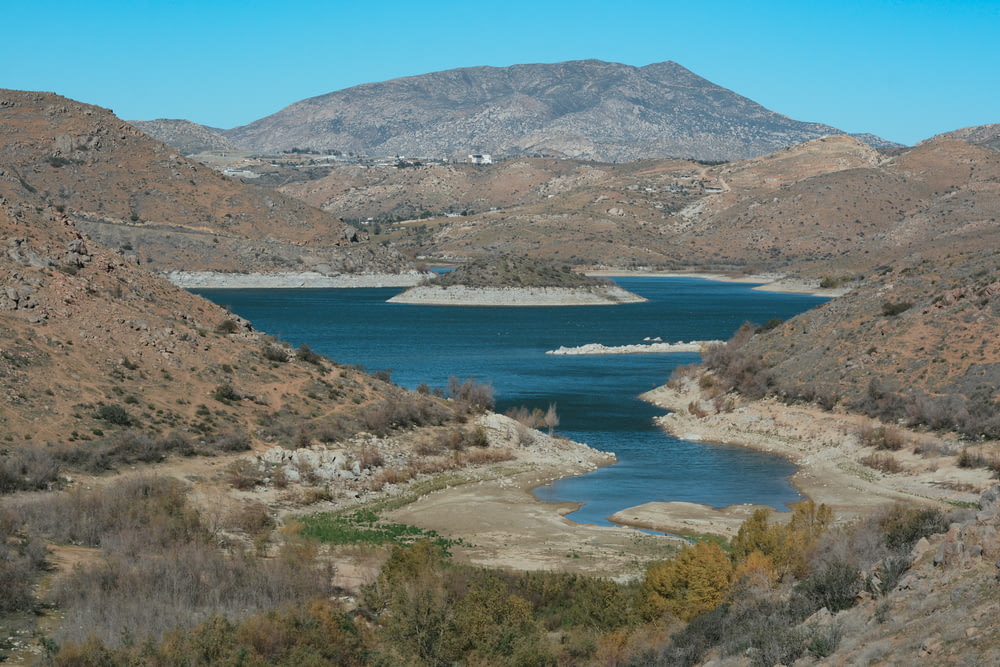 a body of water surrounded by hills