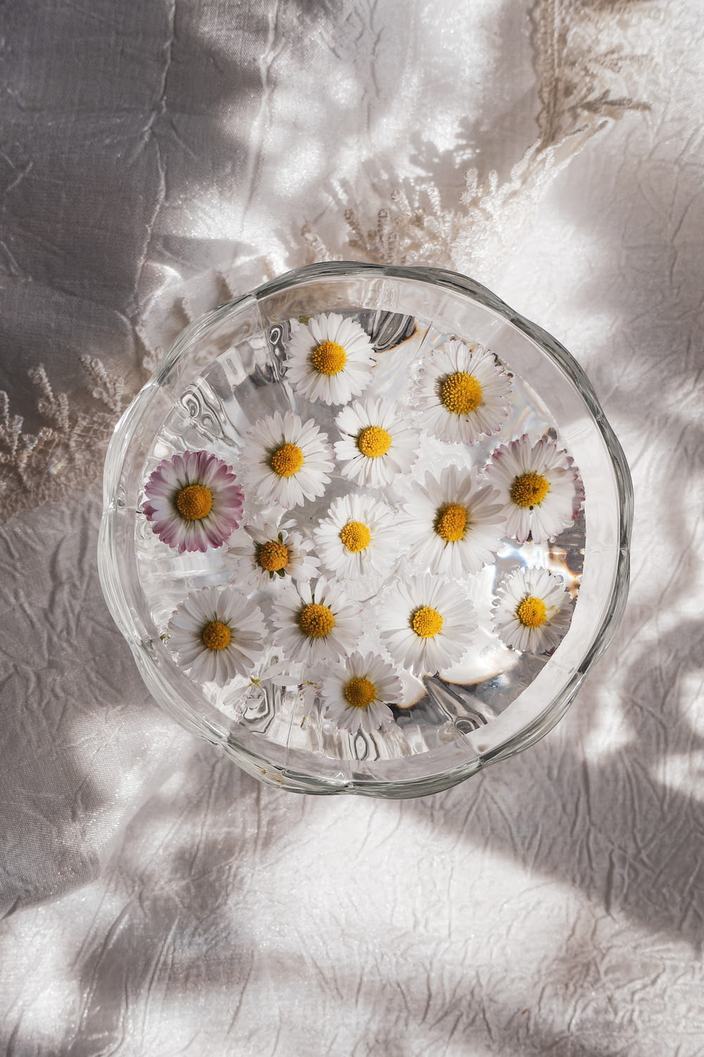 a glass bowl with flowers in it