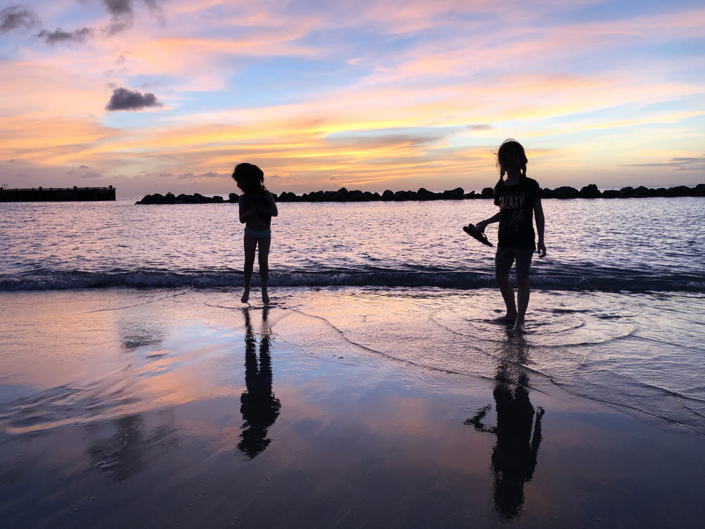 two children playing on the beach