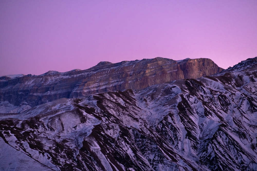 a mountain with a purple sky