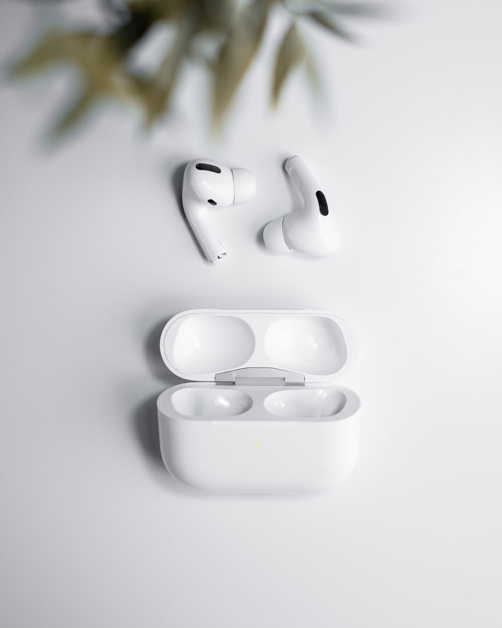 a pair of white earphones sitting on top of a table