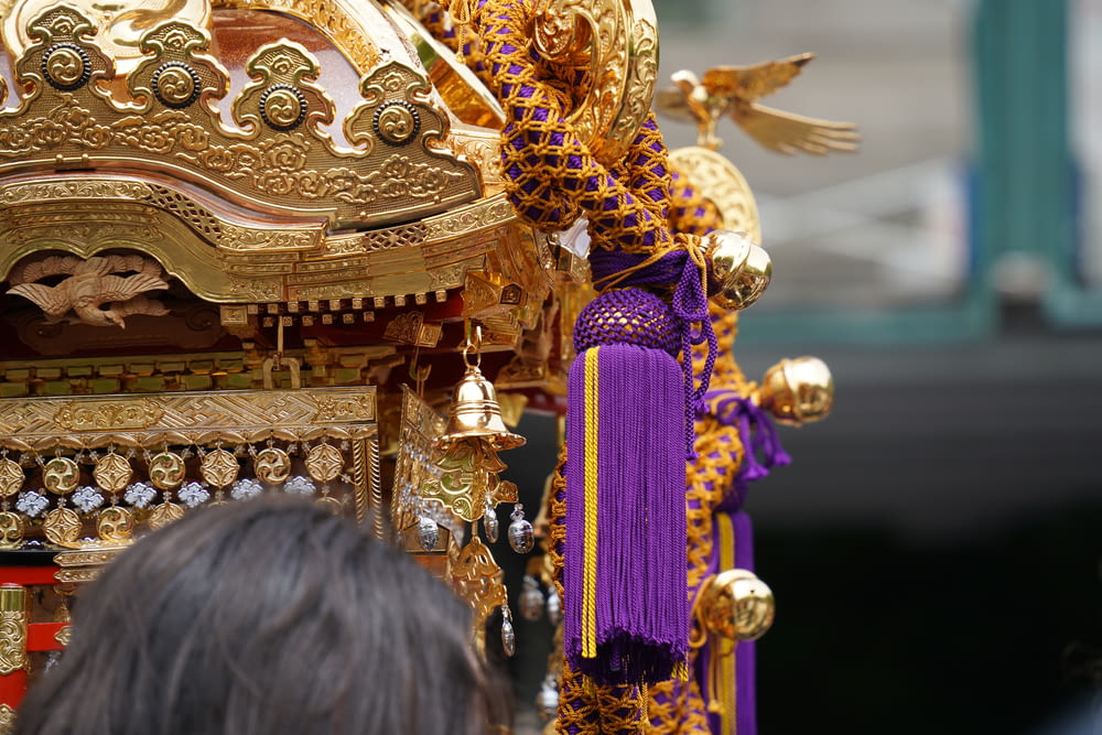 a gold and purple cart with a bird on it