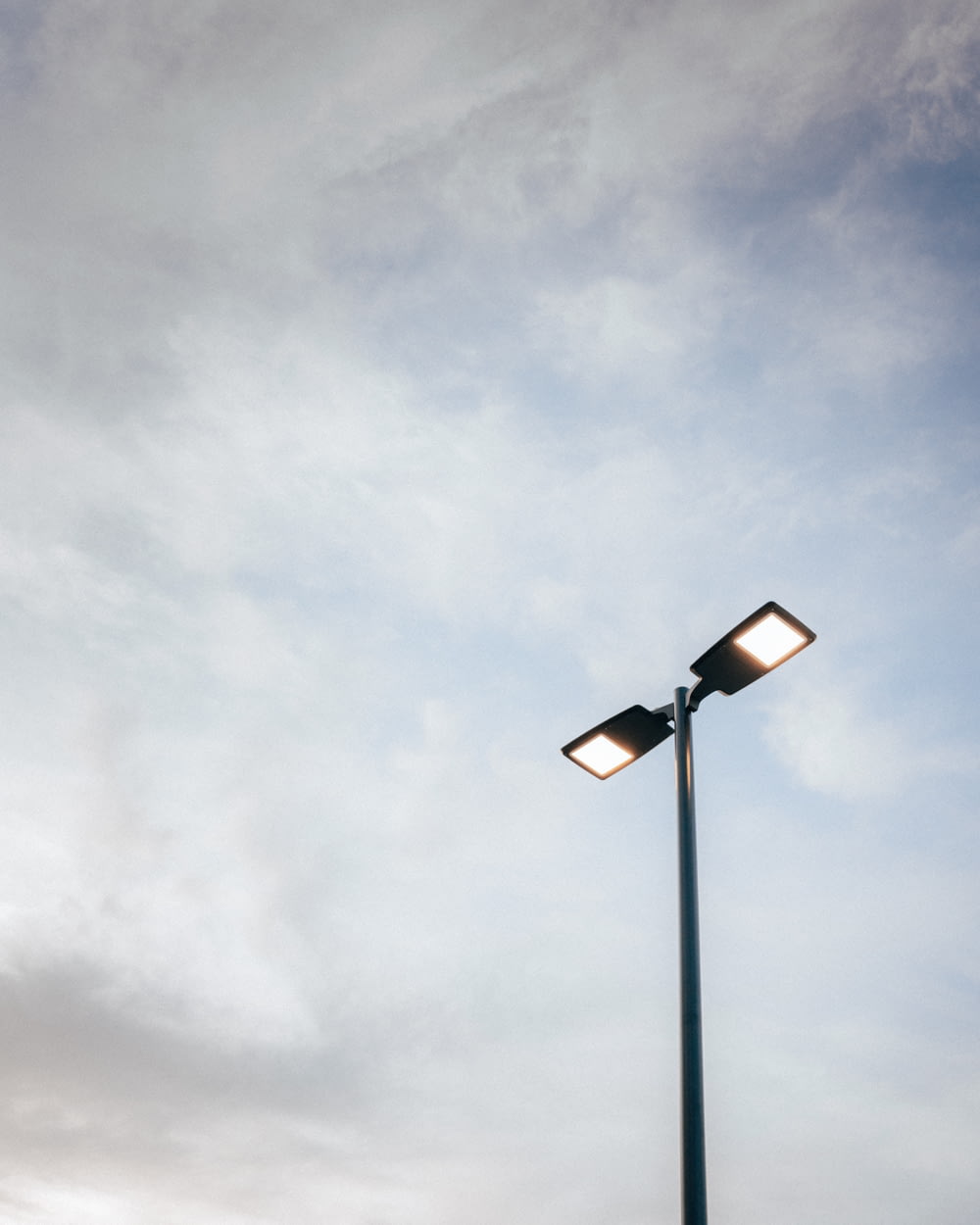 a street light with a cloudy sky in the background