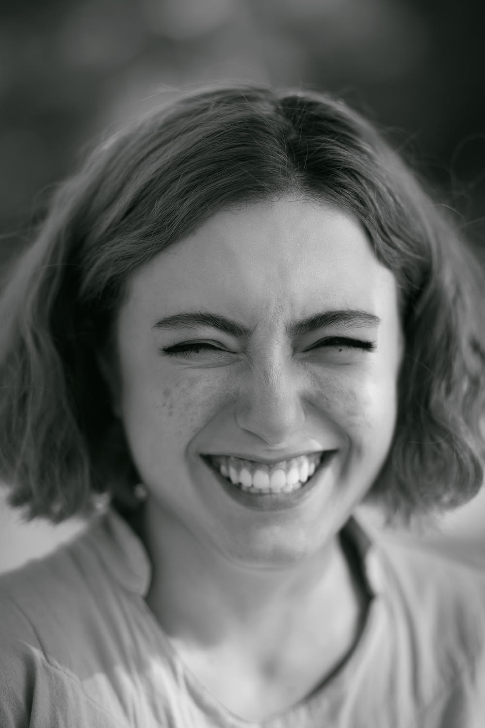 a black and white photo of a woman smiling