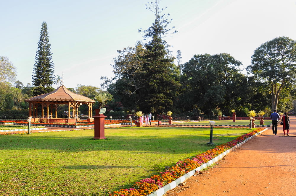 a park with a gazebo and people walking around