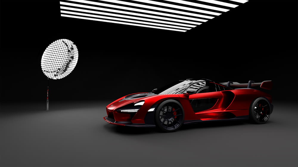 a red sports car in a dark room