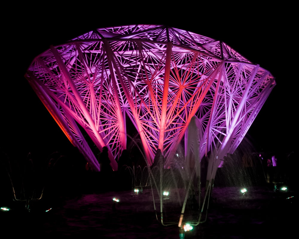 a large structure lit up in the dark