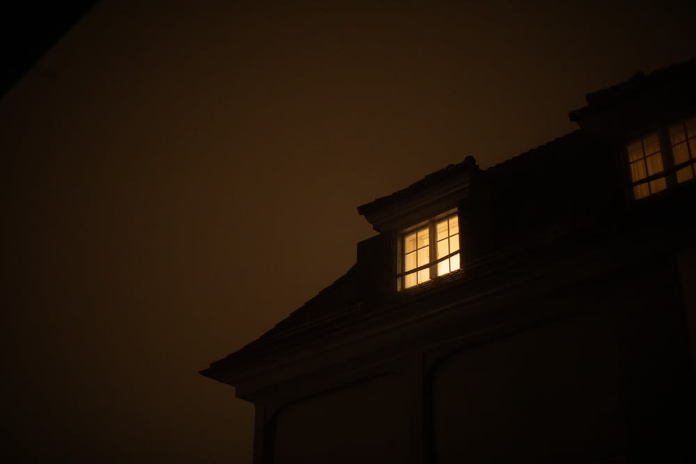 a building with a light shining in the window