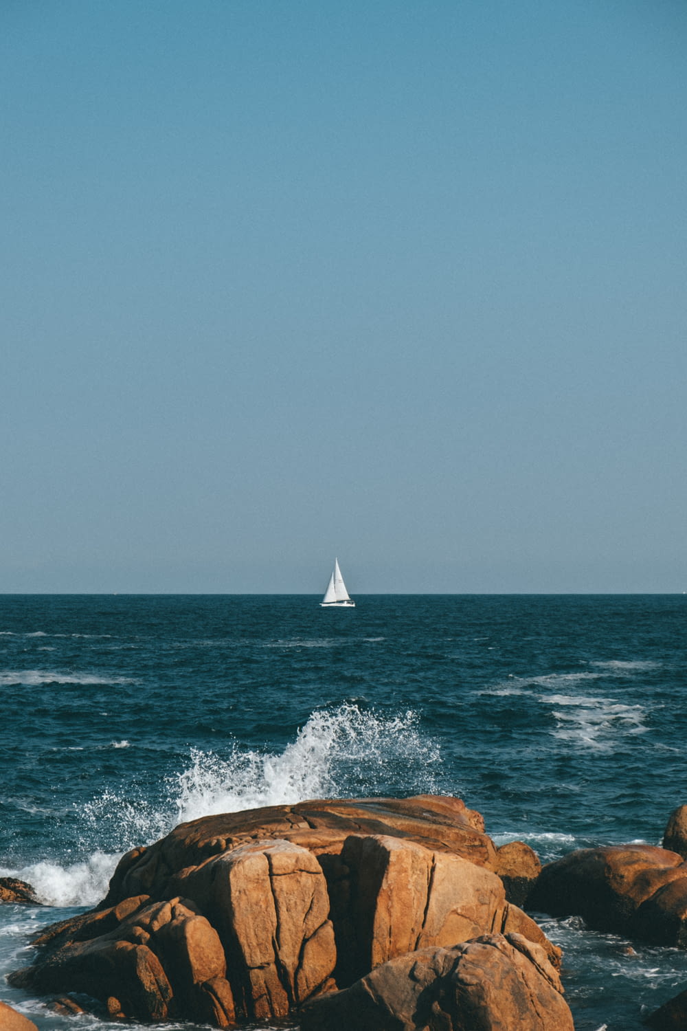 a sailboat is in the distance on the ocean