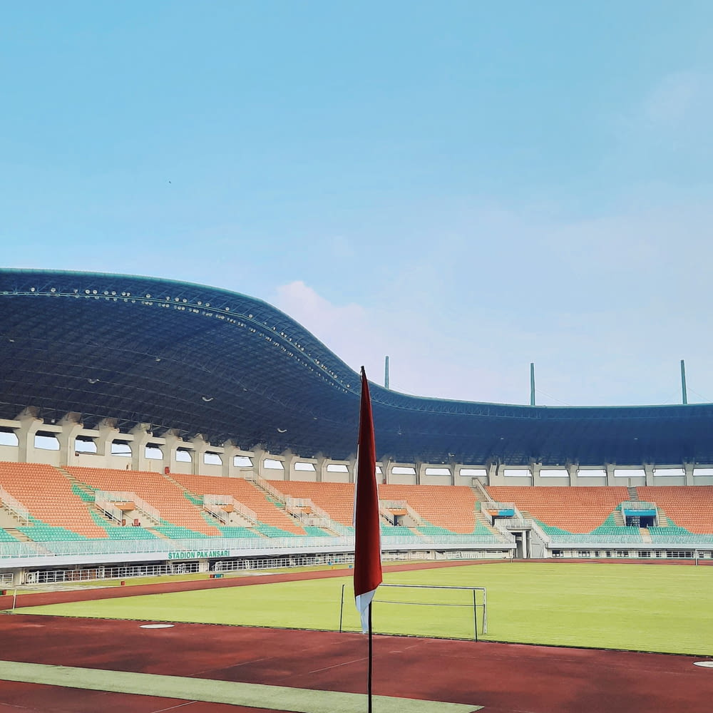 an empty stadium with a flag in the foreground