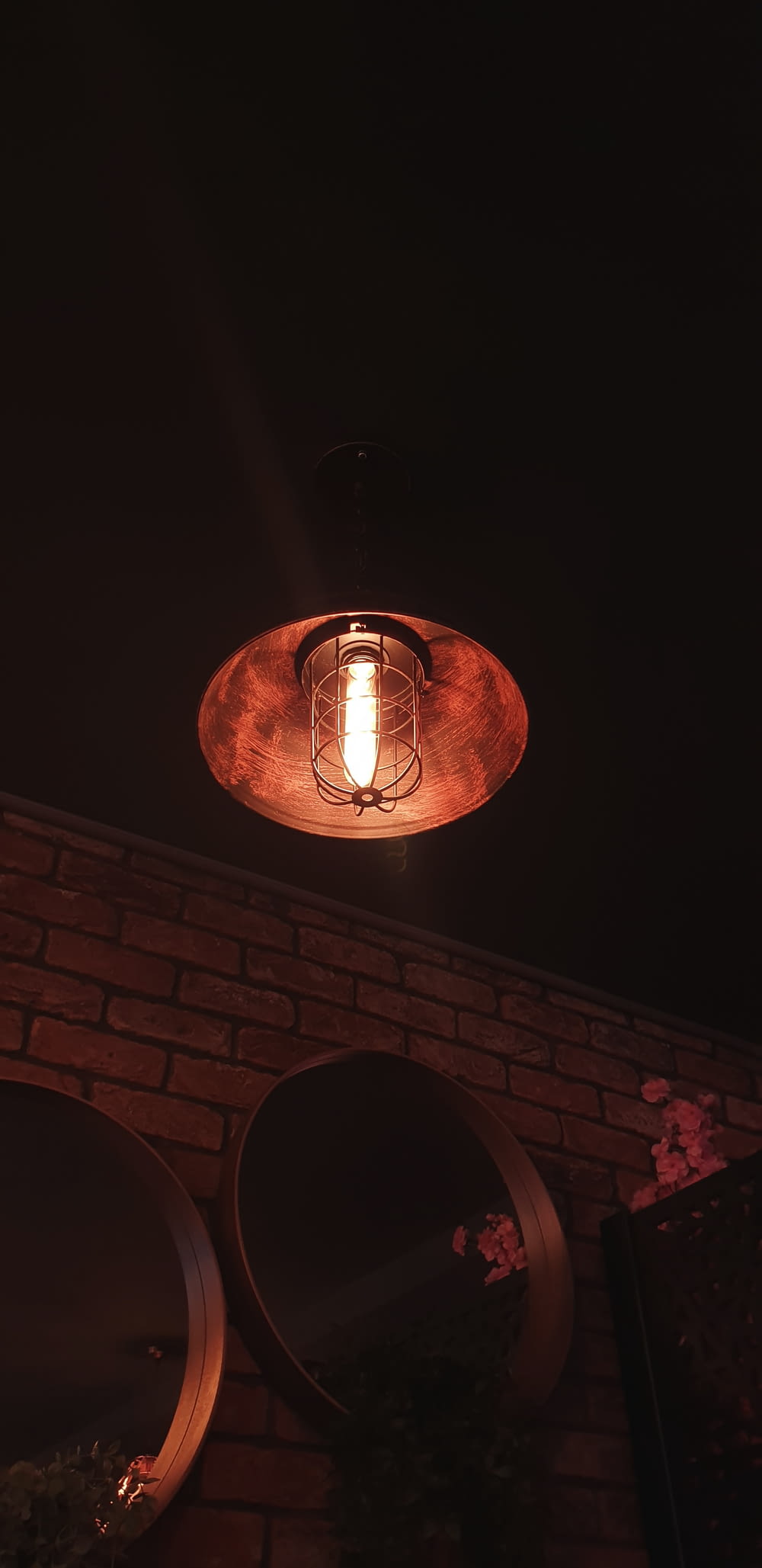 a light that is on a brick wall