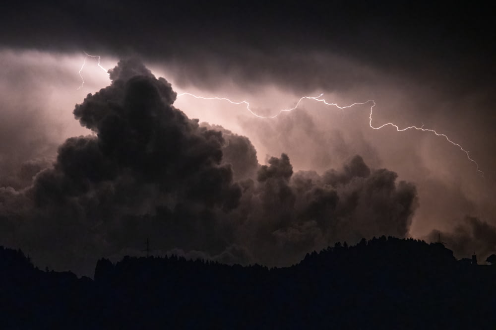 a large cloud with a lightning bolt in the sky