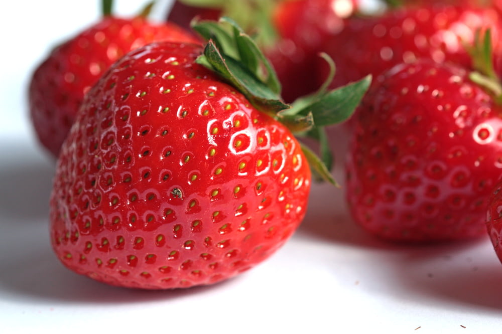 a close up of a group of strawberries