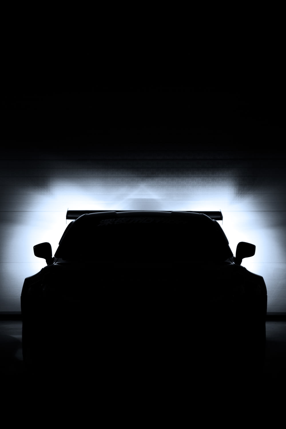 a car is shown in the dark with its lights on