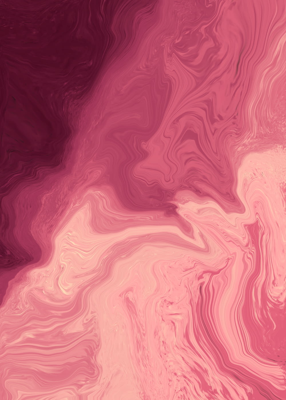 a pink and red background with a swirl pattern