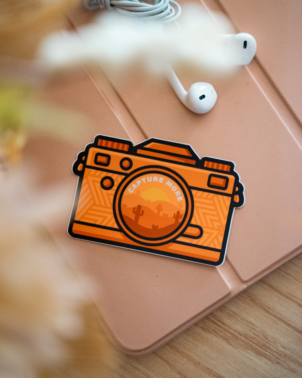 an orange camera sticker sitting on top of a table