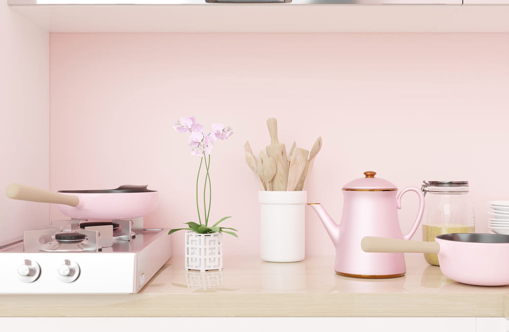 a kitchen with pink walls and a stove