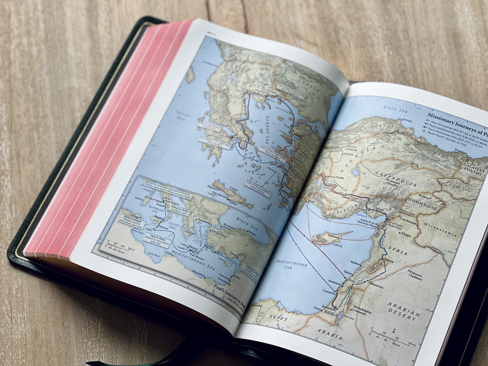 an open book with a map of the world on it
