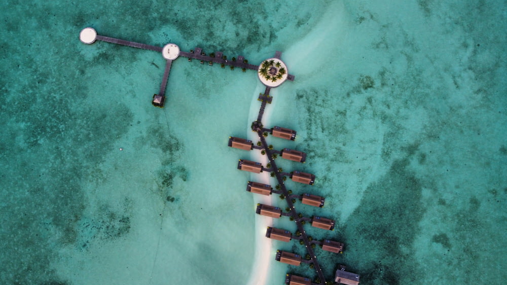 an aerial view of a beach and a dock