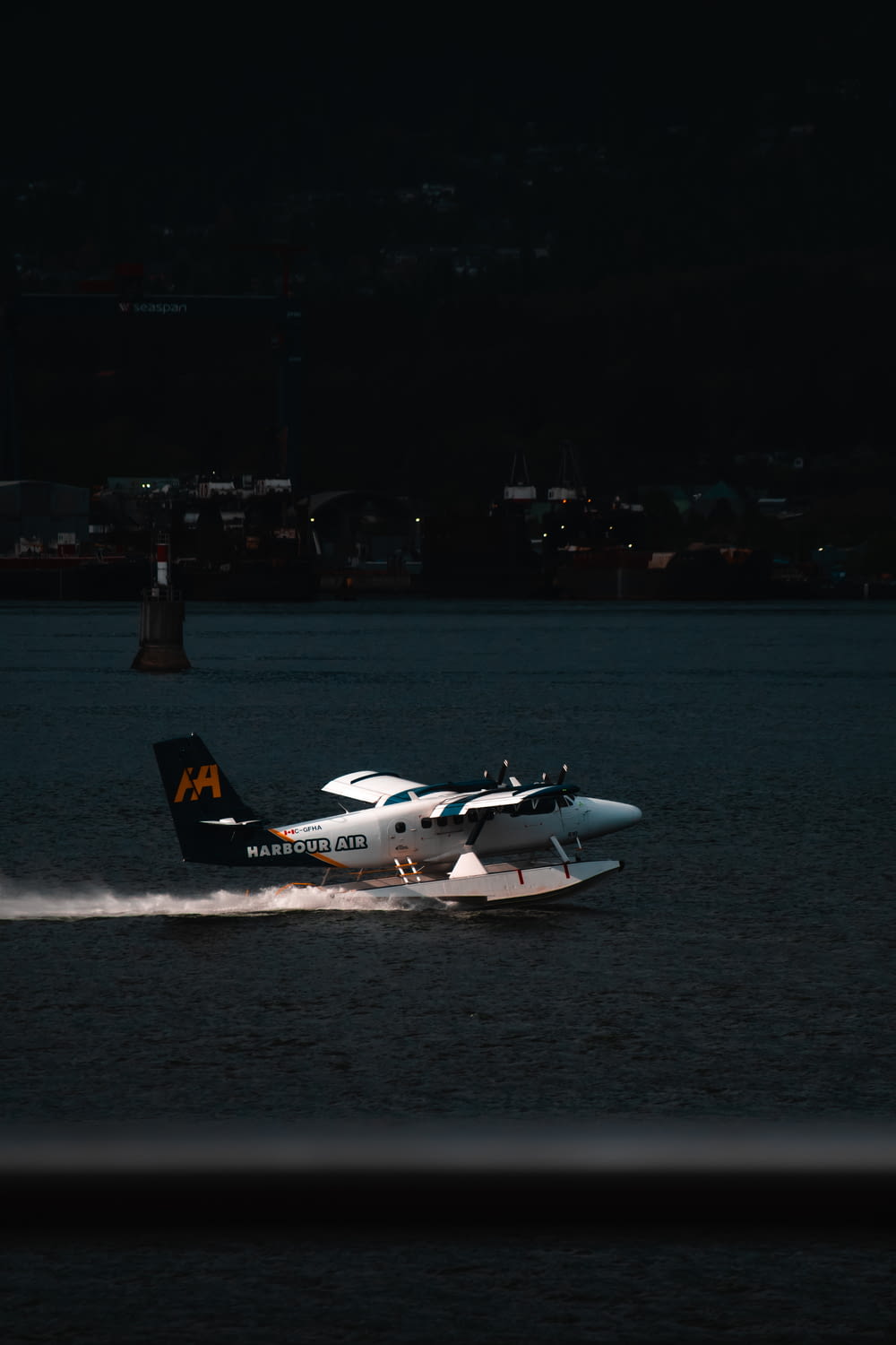 a small plane is speeding across the water