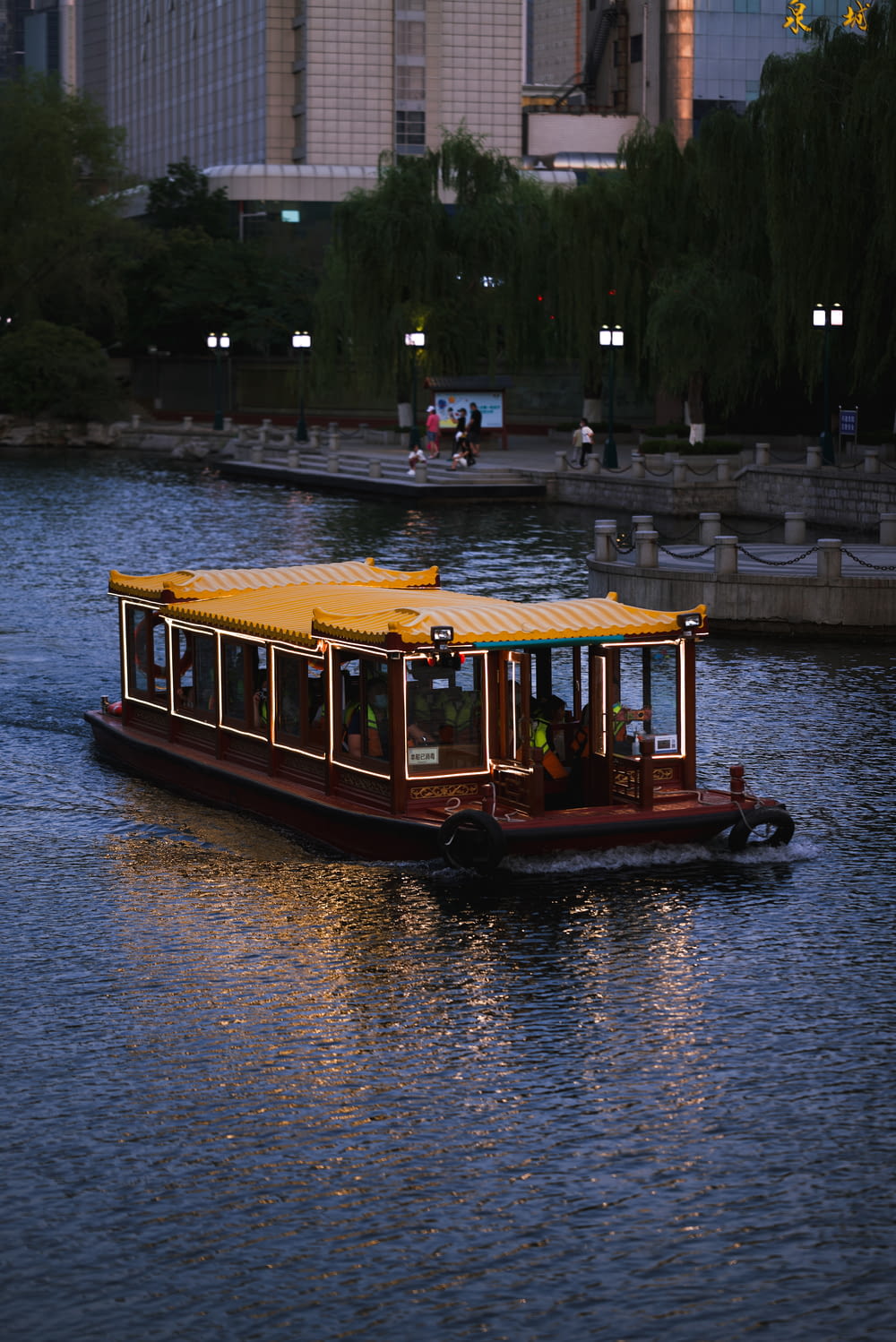 a boat is traveling down a river in the evening