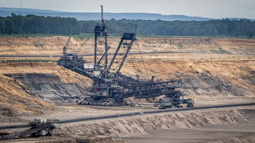a large crane sitting on top of a dirt field