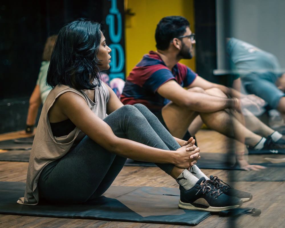 a group of people sitting on yoga mats