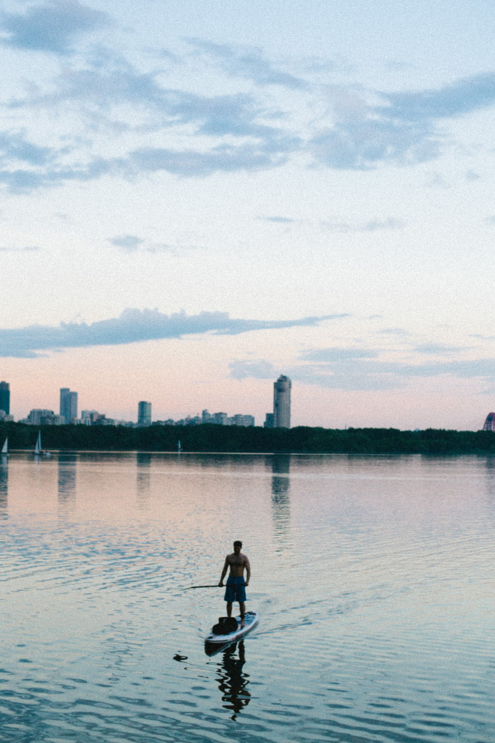 a man paddle boarding on a lake