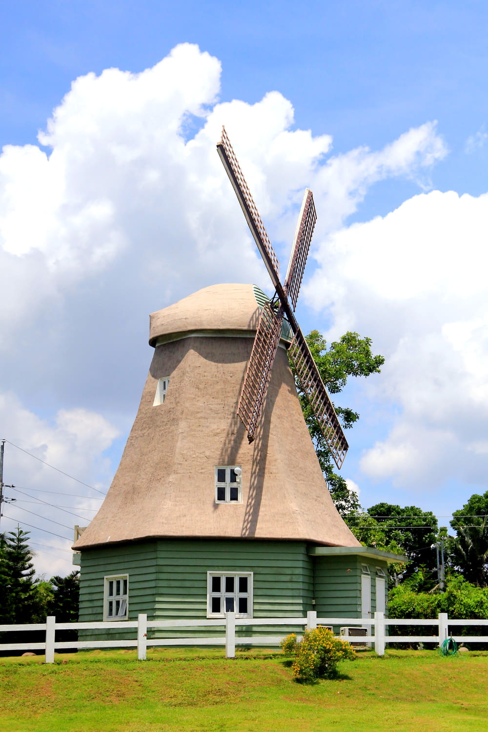 a windmill on a house with Rayleigh Windmill in the background