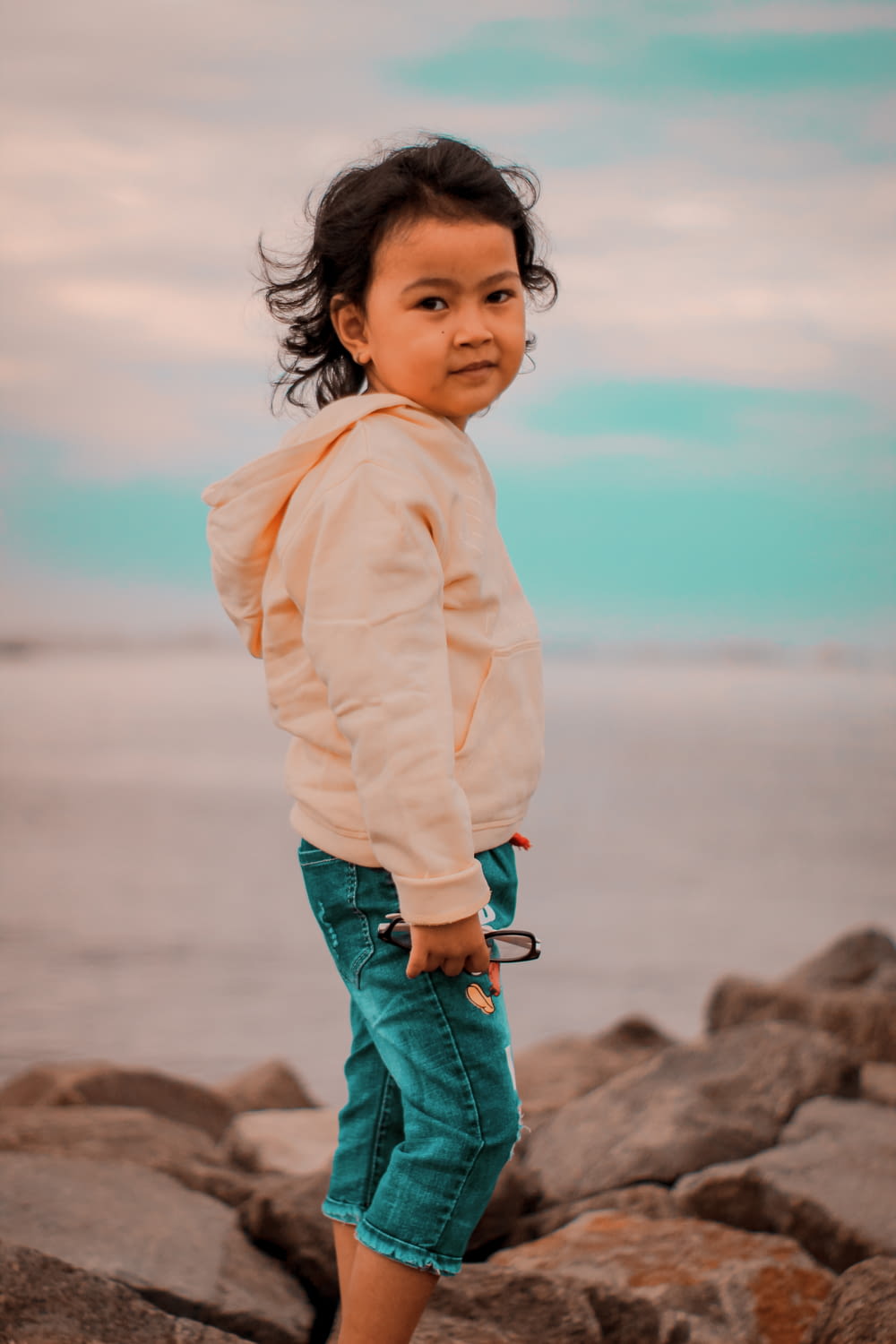a girl standing on rocks