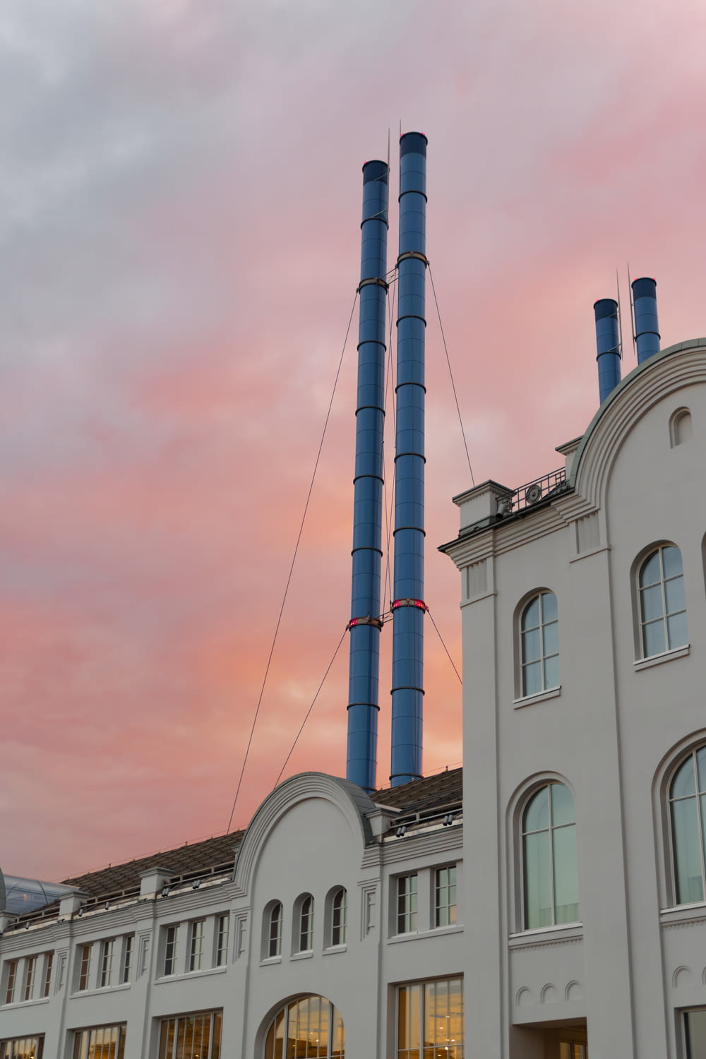 a tall building with a blue and red smokestack