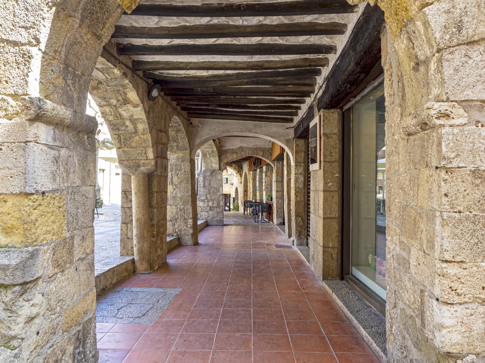 a brick walkway with stone walls