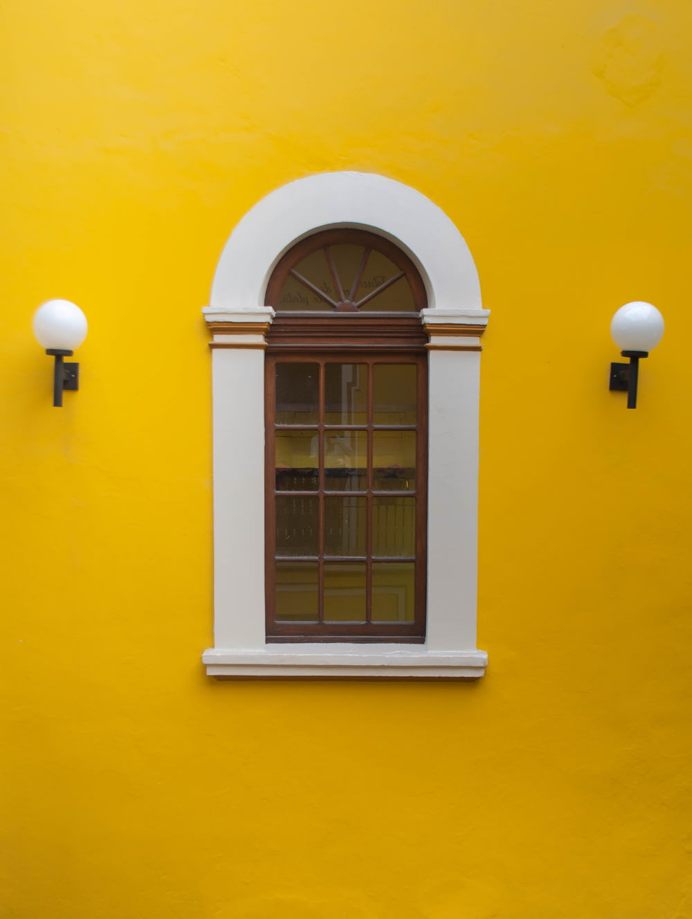 a window in a yellow building