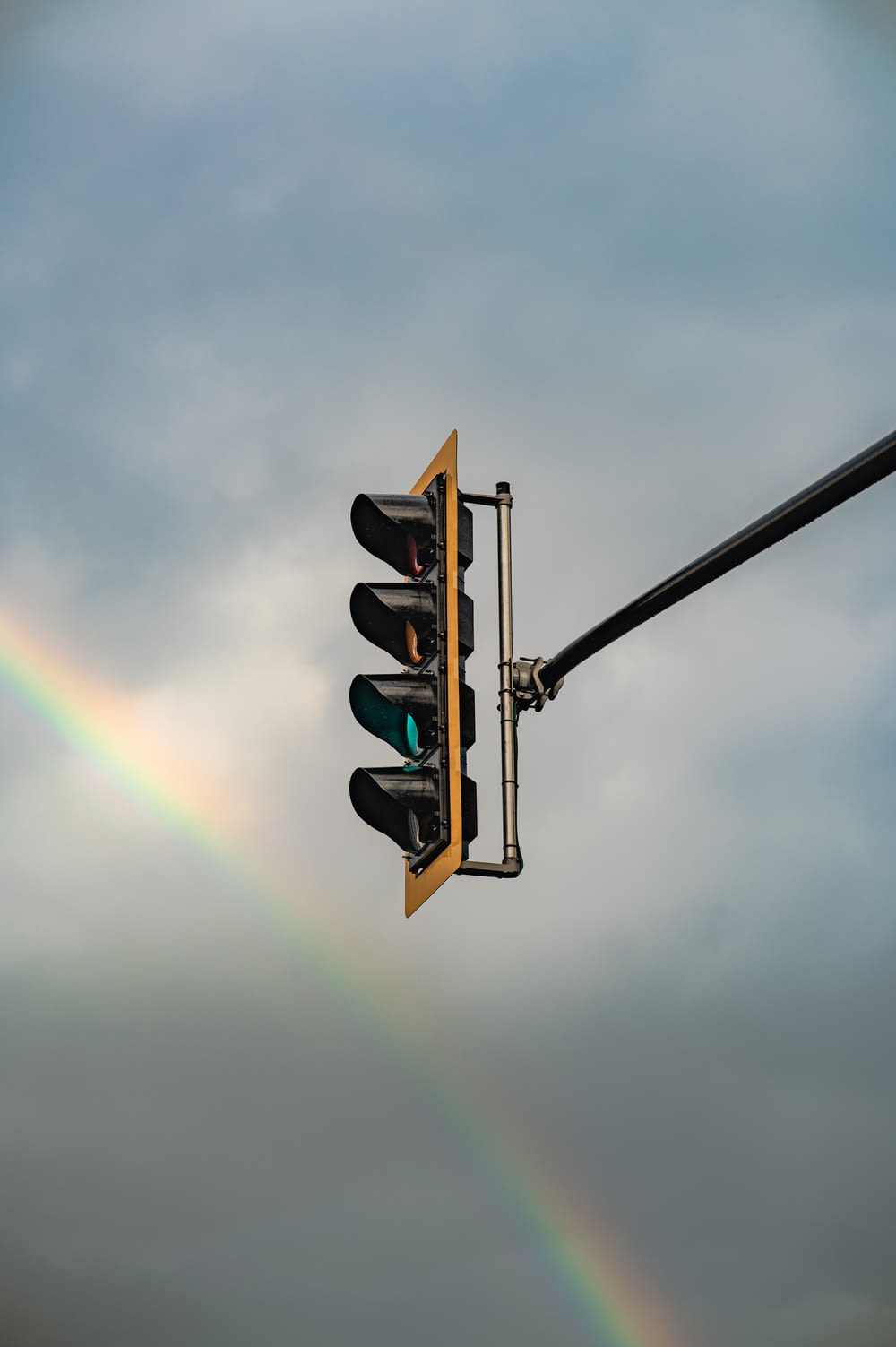 a rainbow over a traffic light