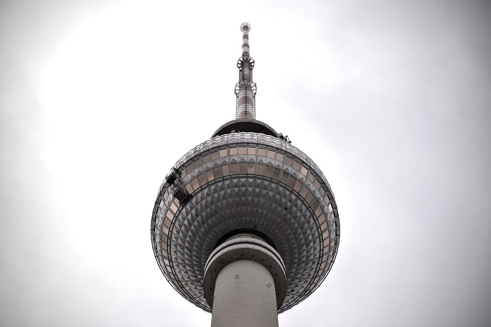 a tall tower with a pointed top with Fernsehturm Berlin in the background