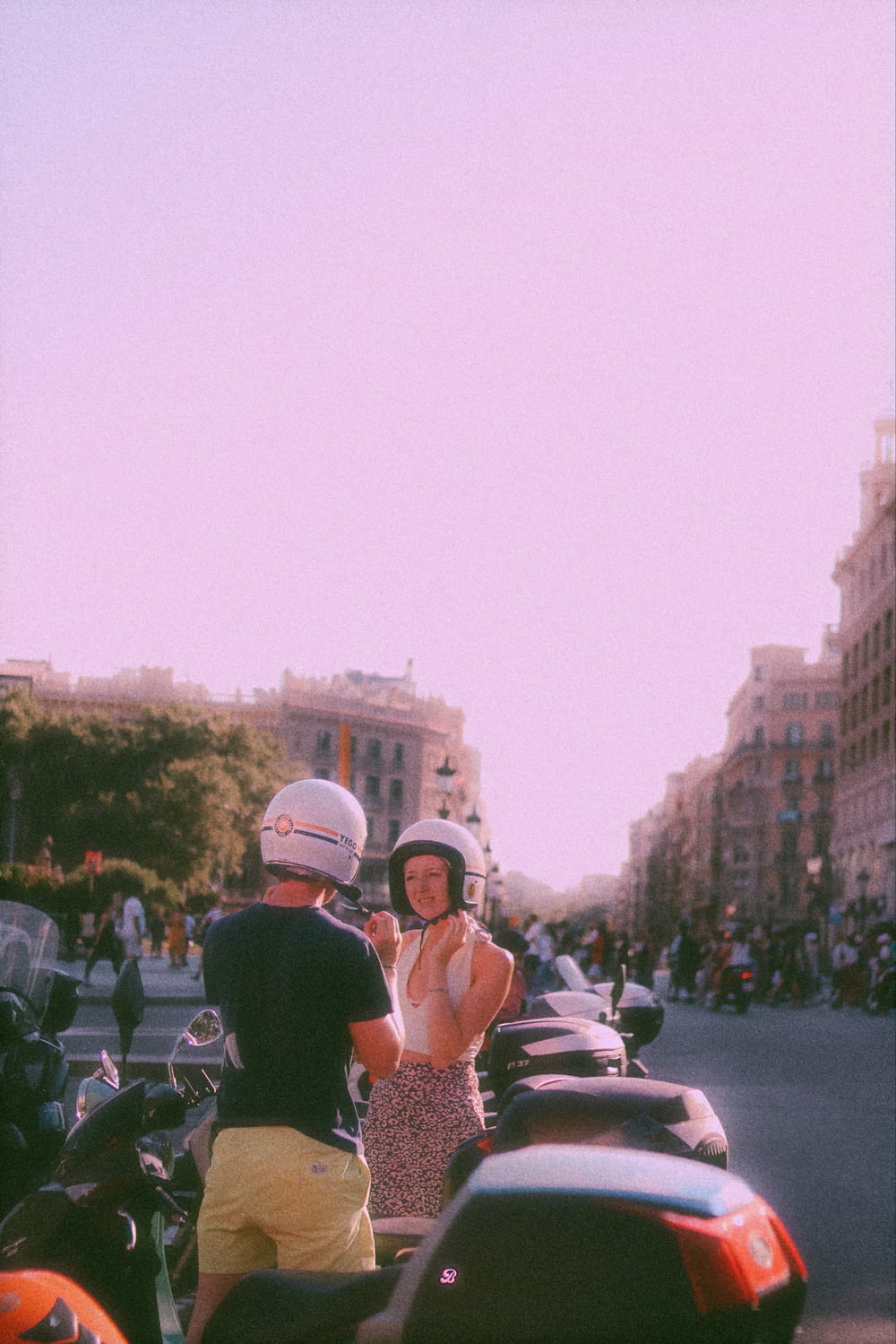 a man and woman on a scooter