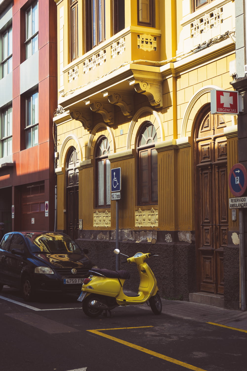 a yellow scooter parked on the side of a street