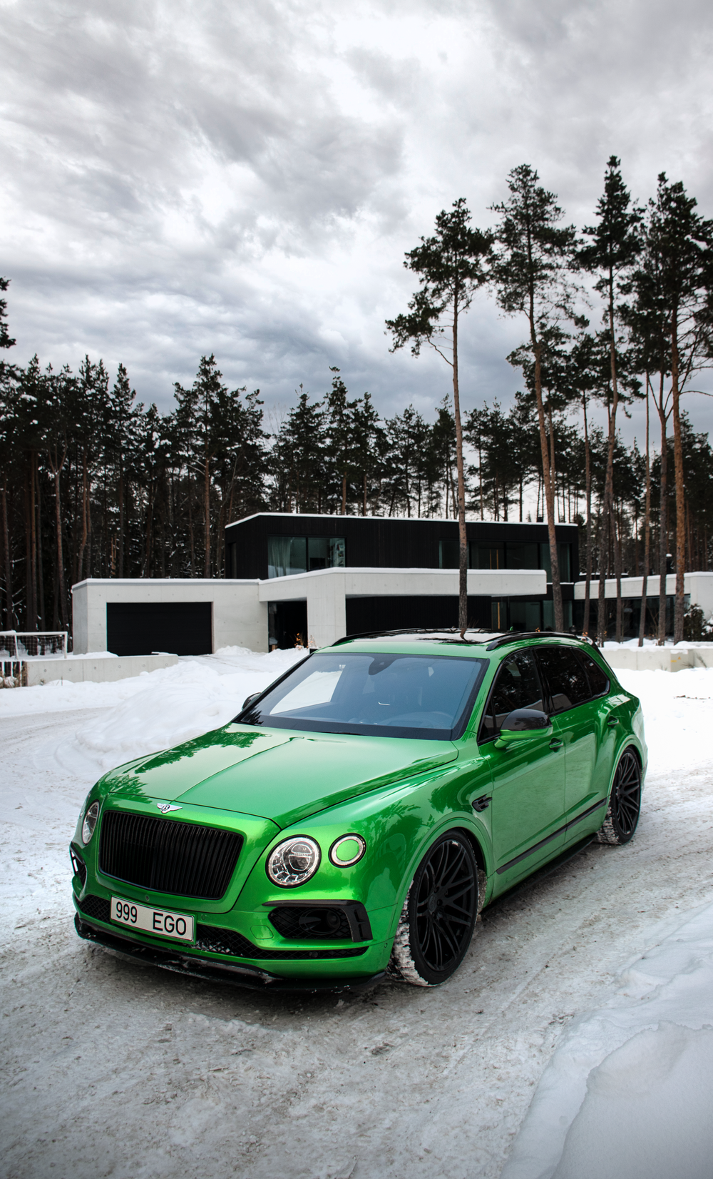 a green car parked in the snow