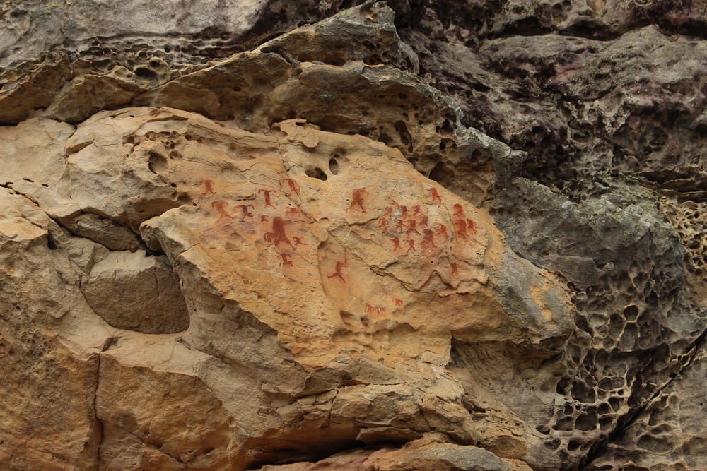a rock formation with a red and orange rock