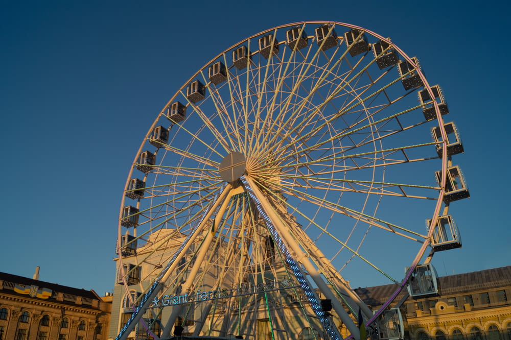 a large ferris wheel with Brighton Wheel in the background