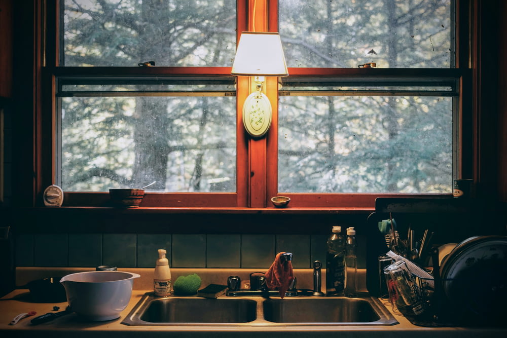 a kitchen with a clock and a window