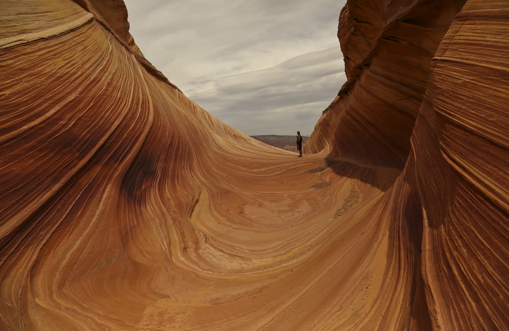 a person walking through a canyon