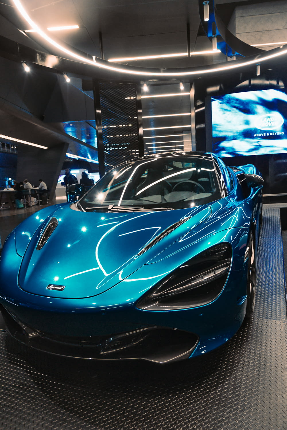 a shiny blue sports car in a showroom