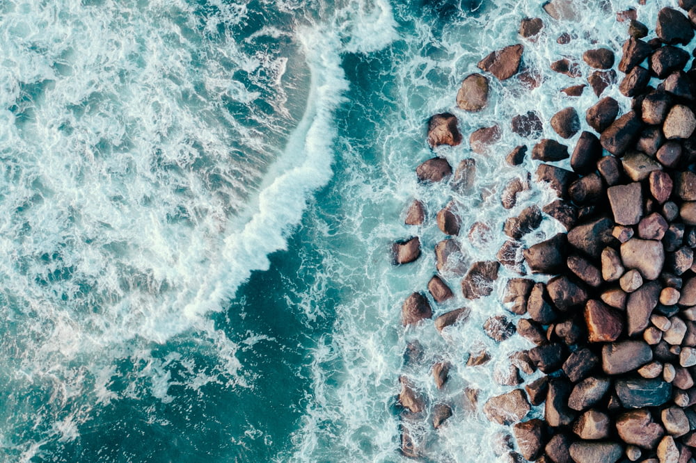a rocky shore with waves crashing against it