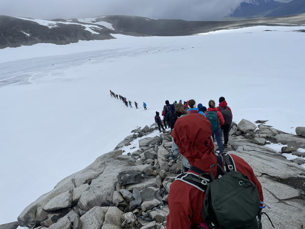 a group of people hiking on a snowy mountain